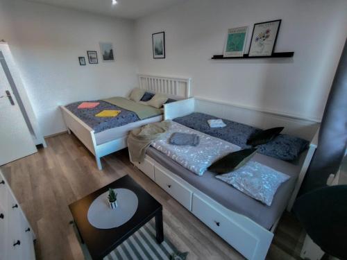a small room with two beds and a table at Apartmánek Protěž in Janske Lazne