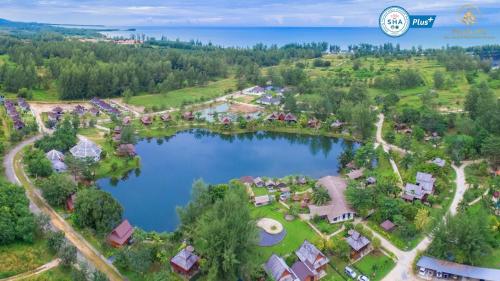 an aerial view of a resort with a lake at ThaiLife Wellness & Meditation Resort- SHA Plus in Khao Lak