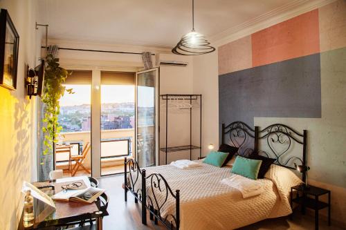 a bedroom with a bed and a table and a balcony at City Lights Rome in Rome