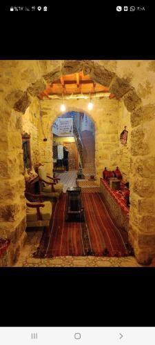 a large stone room with an archway in a building at Dana Gate Lodge in Dana