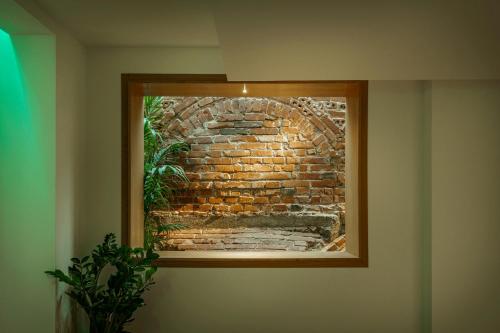 a picture of a brick wall in a frame on a wall at La Boheme Boutique Casa Soare in Bucharest