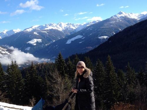 a woman standing on top of a snow covered mountain at Ferienwohnung Traumblick Dolomiten in Winklern