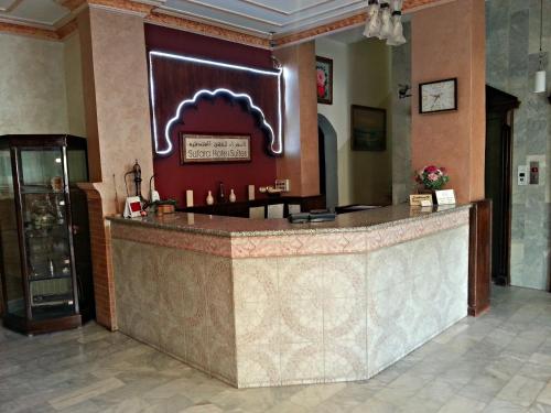 a lobby with a large counter in a building at Sufara Hotel Suites in Amman