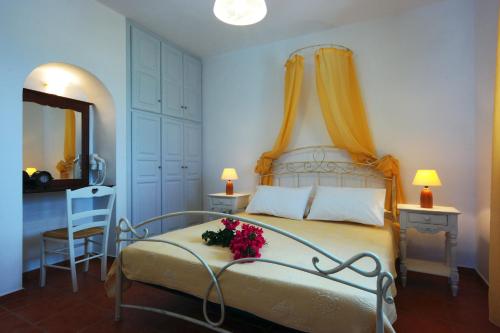 a bedroom with a bed with flowers on it at Belvedere Apartments in Chora Folegandros