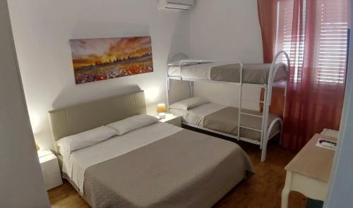 a bedroom with two beds and a bunk bed at Villa Margherita in Marsala