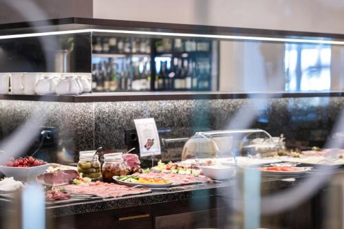 a buffet line with many different types of food at Small & Beautiful Hotel Gnaid in Tirolo