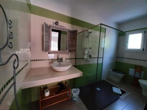 a bathroom with a sink and a shower at Cyrnea B&B - Adults only in Porto-Vecchio