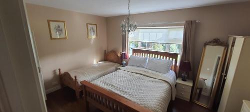 a small bedroom with a bed and a window at Lough Rynn View accommodation Room only in Mohill
