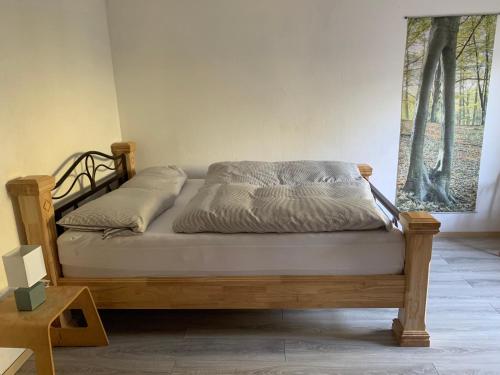 a bed in a room with a wooden frame at Eifeloase Sophia in Nettersheim