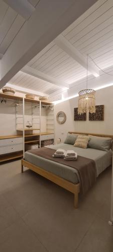 a bedroom with a bed and a chandelier at Appartamento Tra Cielo e Mare Cesenatico in Cesenatico