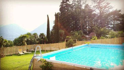 a swimming pool in a yard next to a fence at Schloss-Castel Pienzenau - Guestrooms & Apartments - B&B-Hotel & Restaurant in Merano