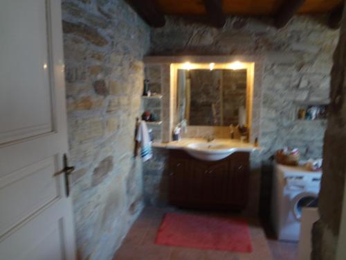 ein Bad mit einem Waschbecken und einem Spiegel in der Unterkunft Luxurious Villa with Private Beach in Apróvaton