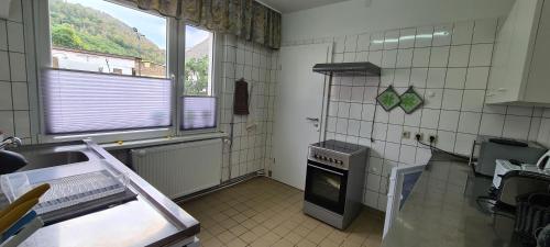 a kitchen with a sink and an oven in it at Auf dem Reiterhof in Wernigerode
