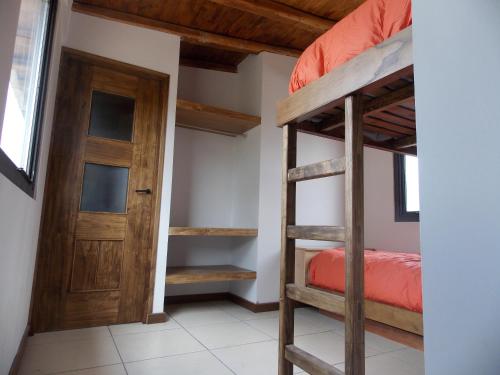 a room with two bunk beds and a door at Chalet Vista Montana in Potrerillos