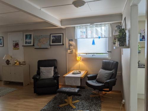 a room with two chairs and a table and a window at Rural apartment in Dverberg