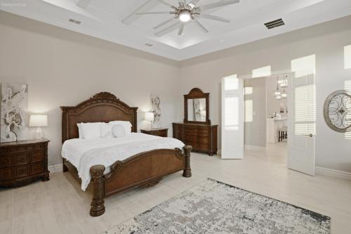 a bedroom with a bed and a clock on the wall at Newly Built Stylish Retreat with Designer Kitchen - Near Park & Beach in Corpus Christi