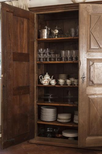 a cabinet filled with plates and cups and dishes at Villino di Porporano in Parma