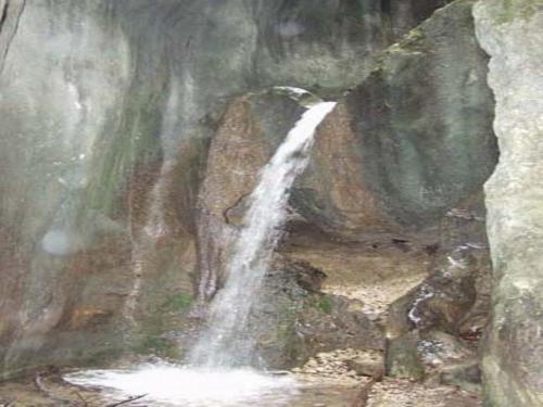 a painting of a waterfall in a cave at Pensiunea Funivia in Săcele