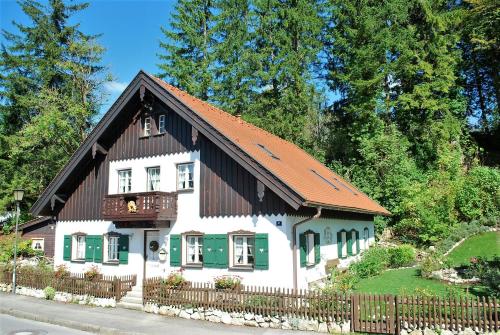 a white house with a brown roof at Villa BeLucky in Oberammergau
