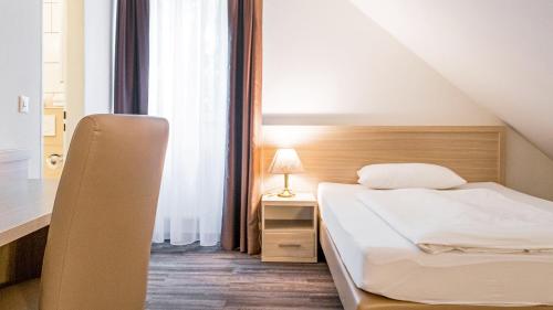 a bedroom with a bed and a nightstand and a bed sidx sidx sidx sidx at Air Hotel Wartburg in Düsseldorf