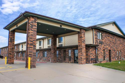 a large brick building with a parking lot at Victorian Inn & Suites-York in York