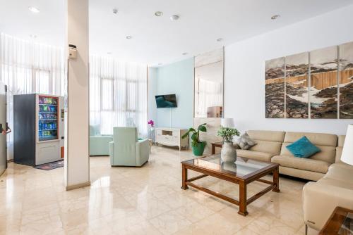 a living room with a couch and a table at Hotel Andrea´s in Los Cristianos