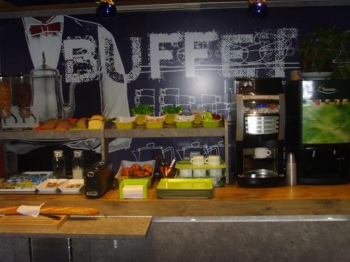a kitchen with a counter with food on it at ibis budget L'Isle Adam in LʼIsle-Adam