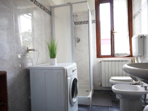 a bathroom with a washing machine and a sink at [Relax&Natura] a 5 minuti da BRESCIA Wifi+ Netflix in Rezzato