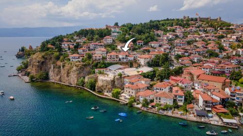 a town on a hill with boats in the water at Villa Una in Ohrid