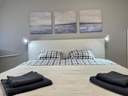 a bedroom with a bed with two black towels on it at panoramic view and free parking in Vilnius