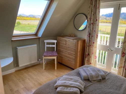 a bedroom with a bed and a dresser and a window at Plockton, Camus Fearn Barn in Plockton