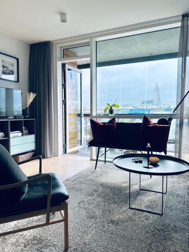 a living room with a couch and a table at 2x Bedroom Luxury Apartment with amazing views! in Reykjavík