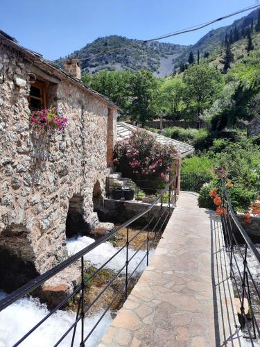 a stone building with stairs leading to a garden at Apartment Neretva in Čapljina