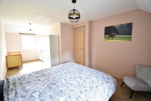 a bedroom with a bed and a picture of a deer at Gîte Jod'en Campagne in Vaux-sur-Sûre
