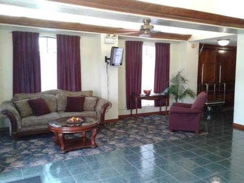 a living room with a couch and a table at Rest Inn Fort Smith in Fort Smith