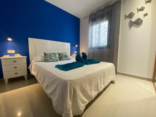 a blue bedroom with a teddy bear sitting on a bed at Oasis Cotillo in Cotillo