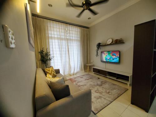 a living room with a couch and a flat screen tv at Doma House Alpine at Lost World of Tambun in Tambun