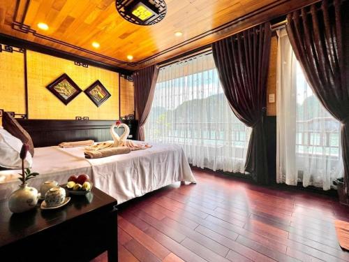 um quarto com uma cama e uma mesa com uma tigela de fruta em Cat Ba Mystery Homestay em Ilha de Cát Bà