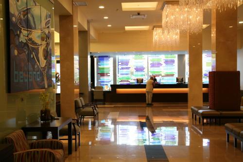 a person standing in the lobby of a restaurant at Century Plaza Hotel in Vancouver
