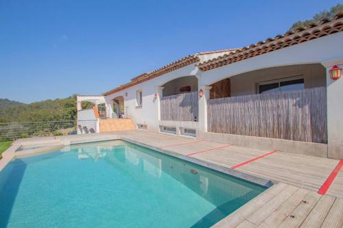 a house with a swimming pool in front of a house at love room avec spa et piscine vu panoramique in Solliès-Toucas