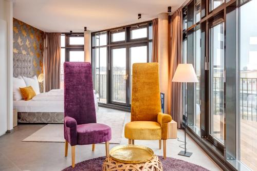 a hotel room with two chairs and a bed at Hotel im Bunker in Munich