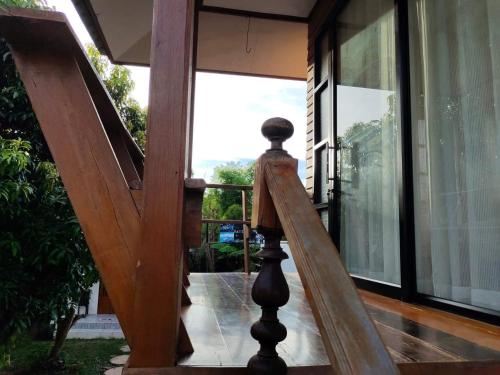 a wooden staircase leading to a house with glass doors at Destiny Home Stay 