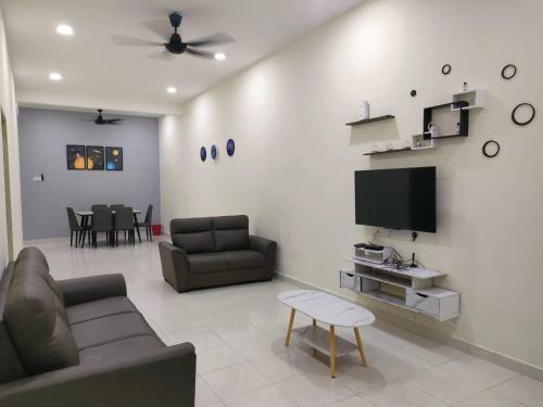 ein Wohnzimmer mit einem Sofa und einem Flachbild-TV in der Unterkunft My Homestay Sitiawan - Astronaut Space House 8 Pax in Sitiawan