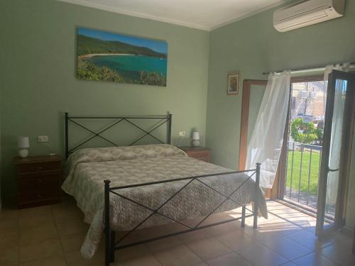a bedroom with a bed and a large window at CASA VACANZE ARCOBALENO in Grosseto