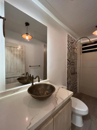 a bathroom with a sink and a toilet at El Percal Hacienda Hotel in Montenegro