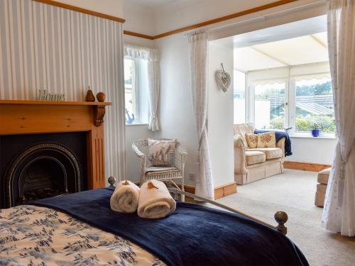 a bedroom with a bed with towels on it at Bay Cottage in Par