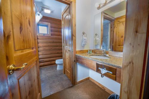 a bathroom with a sink and a toilet at Flying Saddle Resort and Steak House in Alpine