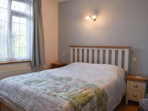 a bedroom with a bed and a window at Lansdowne in Dousland