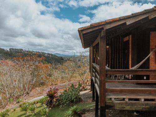 a wooden cabin with a view of a mountain at Pousada Pedra Azul in Pedra Azul