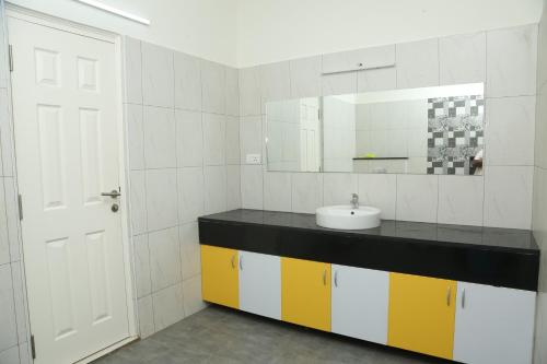a bathroom with a sink and a mirror at The best villa stay- family friendly in Coimbatore